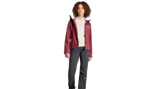 A woman wearing a red adidas Terrex rain jacket